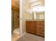 A bathroom featuring a tiled shower, granite vanity and ample under sink storage at 2901 W Rowland Ave, Littleton, CO 80120