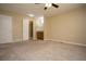 Spacious bedroom leading to an attached bathroom, featuring carpet flooring and neutral walls at 2901 W Rowland Ave, Littleton, CO 80120