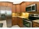 Modern kitchen featuring granite countertops, stainless steel appliances, and wooden cabinets at 2901 W Rowland Ave, Littleton, CO 80120
