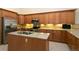 Well-equipped kitchen featuring granite countertops, an island sink, and stainless steel appliances at 2901 W Rowland Ave, Littleton, CO 80120