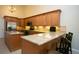 Spacious kitchen boasting granite countertops, wooden cabinets, and stainless steel appliances at 2901 W Rowland Ave, Littleton, CO 80120