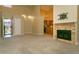 Open-concept living room featuring high ceilings, a fireplace, and seamless flow into the kitchen at 2901 W Rowland Ave, Littleton, CO 80120