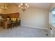 Cozy eating area adjacent to a kitchen and lit by a chandelier at 2901 W Rowland Ave, Littleton, CO 80120