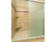 A shower featuring tile, built in shelving, and a glass door at 2901 W Rowland Ave, Littleton, CO 80120