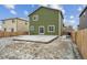 A backyard featuring a stone patio, sliding glass doors, and green siding at 7210 Fall River Cir, Frederick, CO 80530