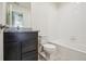 Bathroom featuring granite vanity, white tile bathtub and toilet at 7210 Fall River Cir, Frederick, CO 80530