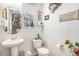 Clean bathroom with pedestal sink, toilet and shower at 17217 E Exposition Dr, Aurora, CO 80017