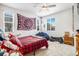 Bright bedroom with large windows, cozy furniture, and unique wall decor creates a relaxing atmosphere at 17217 E Exposition Dr, Aurora, CO 80017