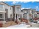 Stylish townhome showcases modern architectural design with gray siding and charming front entrance at 17217 E Exposition Dr, Aurora, CO 80017