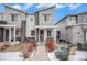 Two-story townhome with gray siding, stone accents, and a landscaped front yard at 17217 E Exposition Dr, Aurora, CO 80017