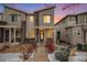 Modern townhome exterior featuring stylish gray siding, stone accents, and inviting walkway at 17217 E Exposition Dr, Aurora, CO 80017