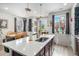 Bright kitchen island featuring a stainless steel sink, modern fixtures, and natural light at 17217 E Exposition Dr, Aurora, CO 80017