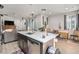 Modern kitchen with an island featuring a stainless steel dishwasher, sink and a white countertop at 17217 E Exposition Dr, Aurora, CO 80017