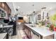 Modern kitchen with an island, stainless steel appliances, and tiled backsplash at 17217 E Exposition Dr, Aurora, CO 80017