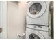 Convenient laundry area with a stacked washer and dryer unit and space-saving design at 17217 E Exposition Dr, Aurora, CO 80017