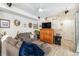 Relaxing living room featuring a cozy sofa, entertainment center, and stylish decor at 17217 E Exposition Dr, Aurora, CO 80017