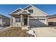 Two-story craftsman style home with gray siding, brick accents and a two-car garage at 5015 N Quemoy St, Aurora, CO 80019