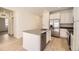 Modern kitchen with white cabinets, stainless steel appliances and an island at 5015 N Quemoy St, Aurora, CO 80019