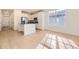 Open concept kitchen with island and hardwood floors at 5015 N Quemoy St, Aurora, CO 80019