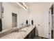 Bathroom featuring double sinks, granite countertops, and a walk-in closet at 5332 13Th St, Frederick, CO 80504