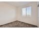 A bright bedroom featuring neutral walls, carpet flooring, and a window with blinds at 5332 13Th St, Frederick, CO 80504