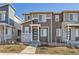 A modern two-story house featuring a stone facade, a front door, and a well-maintained yard at 5332 13Th St, Frederick, CO 80504