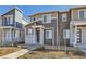 A view of a two-story townhome with stone accents, modern design, and drought-resistant landscaping at 5332 13Th St, Frederick, CO 80504