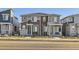 Exterior street view of townhomes with stone accents, modern design, and drought-resistant landscaping at 5332 13Th St, Frederick, CO 80504