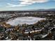 Aerial view showcasing a townhouse community near a frozen lake with mountain views at 1176 E 130Th Ave # C, Thornton, CO 80241