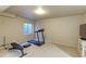 Finished basement area with a treadmill and weight bench at 1176 E 130Th Ave # C, Thornton, CO 80241