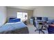 Bedroom with a bed, desk, and multiple monitors at 1176 E 130Th Ave # C, Thornton, CO 80241