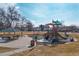 A colorful playground with slides and climbing equipment, and a covered picnic table nearby at 8722 Dudley Ct, Arvada, CO 80005