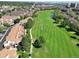 Aerial view of townhomes on golf course showing beautiful green landscape with ponds and residential community at 3026 W Prentice Ave # G, Littleton, CO 80123