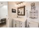 Updated bathroom featuring vanity with wood framed mirror, decorative lighting, and stylish towel rack at 3026 W Prentice Ave # G, Littleton, CO 80123