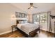 Bedroom with hard wood floors, industrial style furniture and a large window at 3026 W Prentice Ave # G, Littleton, CO 80123