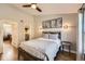 Bedroom with neutral gray colored walls, industrial style furniture and ample closet space at 3026 W Prentice Ave # G, Littleton, CO 80123