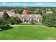 Townhome with a brick facade, mature trees and a green lawn in front at 3026 W Prentice Ave # G, Littleton, CO 80123