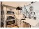 Modern kitchen with stainless steel appliances, white countertops and a view of the open concept living area at 3026 W Prentice Ave # G, Littleton, CO 80123