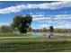 Scenic view of a community pond, lined with vibrant trees under a blue sky at 3026 W Prentice Ave # G, Littleton, CO 80123