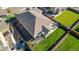 Aerial view showcases a backyard with a patio, green lawn, trampoline and privacy fencing, perfect for outdoor enjoyment at 697 Gamble Oak St, Brighton, CO 80601
