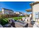 Inviting backyard patio with stylish seating and a view of the well-maintained lawn and neighborhood at 697 Gamble Oak St, Brighton, CO 80601