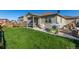 Spacious backyard with green grass, a covered patio and a shed for storage at 697 Gamble Oak St, Brighton, CO 80601