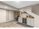 Finished basement featuring a mini wine fridge, a wooden countertop, gray cabinets and plush carpet at 697 Gamble Oak St, Brighton, CO 80601