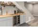 Finished basement with a wooden countertop and mini wine fridge under the stairs for storage at 697 Gamble Oak St, Brighton, CO 80601