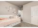 Cozy bedroom featuring a white frame twin bed with trundle and neutral gray paint at 697 Gamble Oak St, Brighton, CO 80601