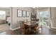 Cozy dining area with a rustic wooden table and ladder shelf, with views of the backyard at 697 Gamble Oak St, Brighton, CO 80601