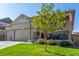 Beautifully landscaped front yard with a charming porch and craftsman-style details at 697 Gamble Oak St, Brighton, CO 80601