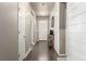 Inviting hallway features durable wood-look floors, neutral paint, and a shiplap accent wall, creating a modern transition space at 697 Gamble Oak St, Brighton, CO 80601