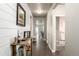 Hallway showcasing wood-look flooring, shiplap accent wall, and stylish decor, creating a welcoming and modern entryway at 697 Gamble Oak St, Brighton, CO 80601