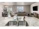 Gourmet kitchen area with granite counters, stainless steel appliances, and an open layout at 697 Gamble Oak St, Brighton, CO 80601
